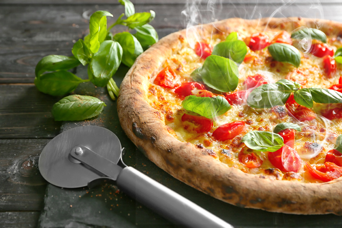 Delicious pizza on slate plate